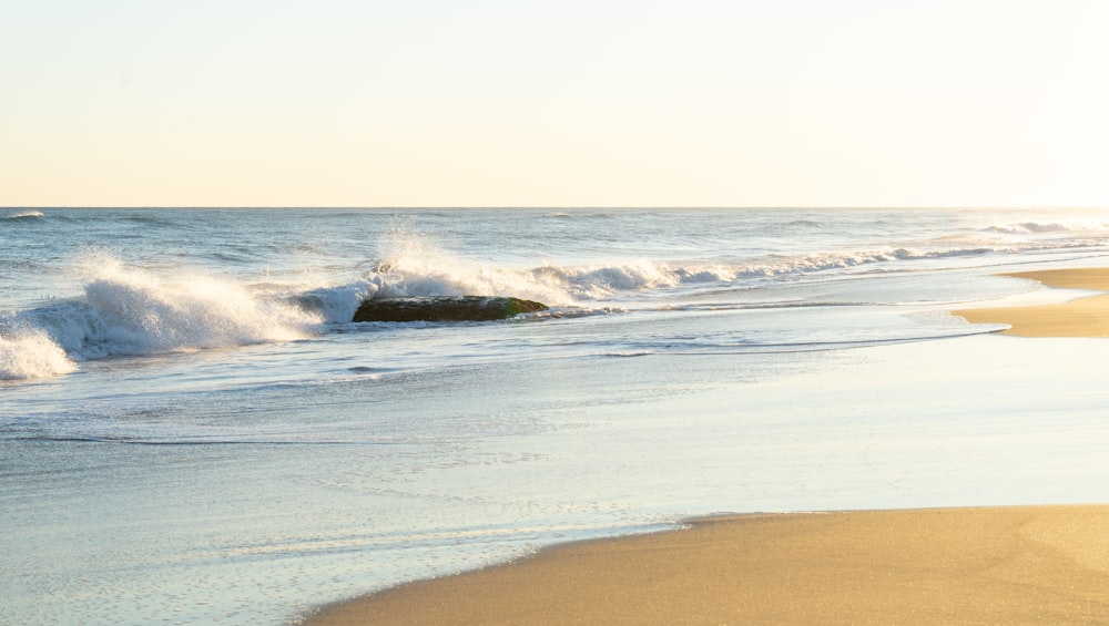 ocean waves crashing on shore during daytime