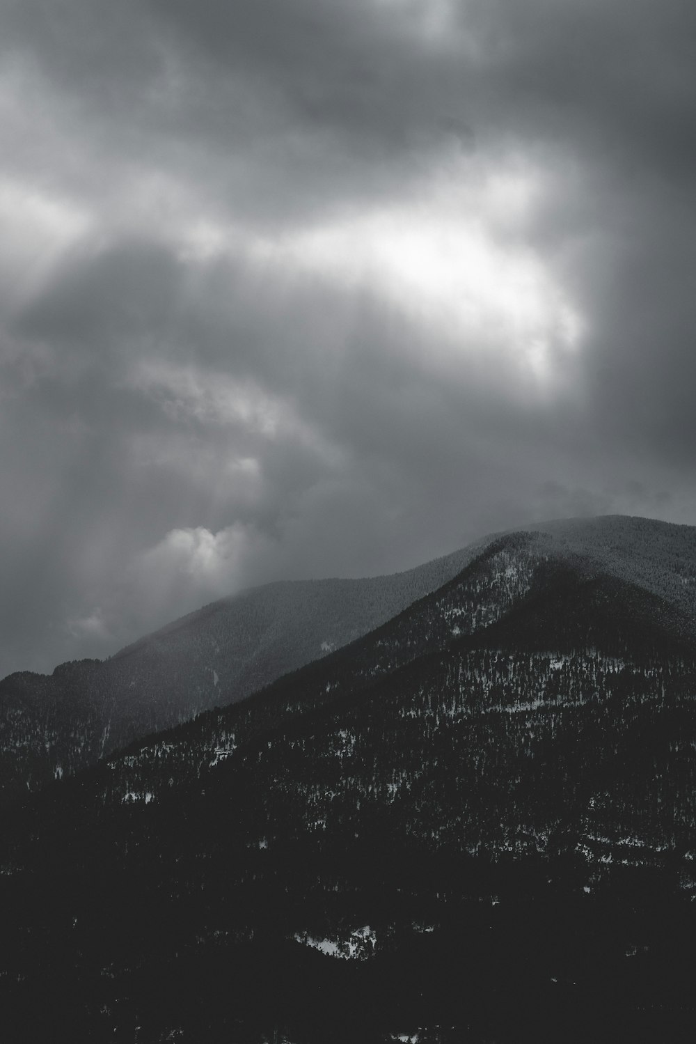 black mountains under white clouds