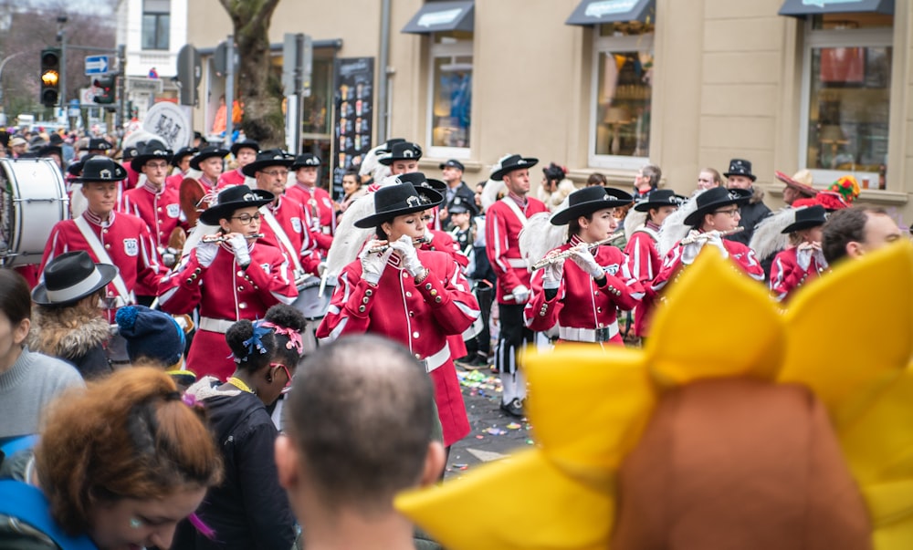 people in yellow uniform standing on street during daytime