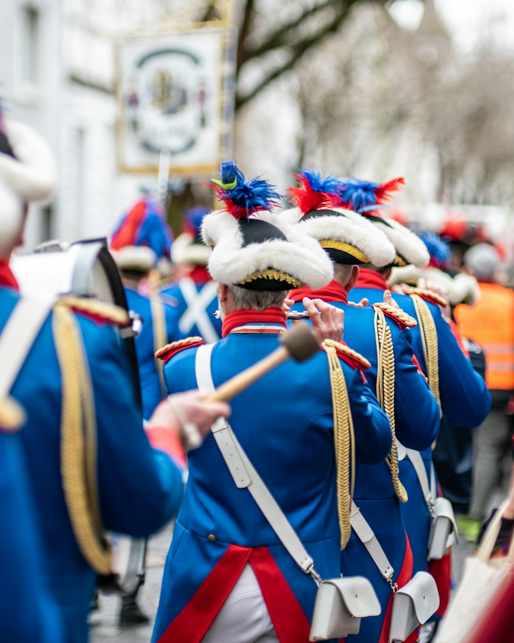 people in blue and white costume standing on street during daytime