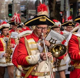 people in red and white traditional dress playing musical instruments during a parade