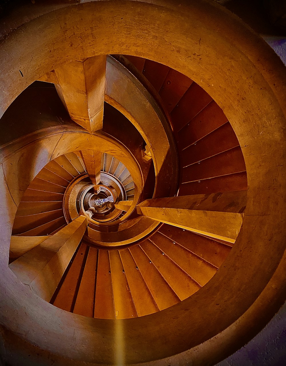 brown spiral staircase with brown wooden railings