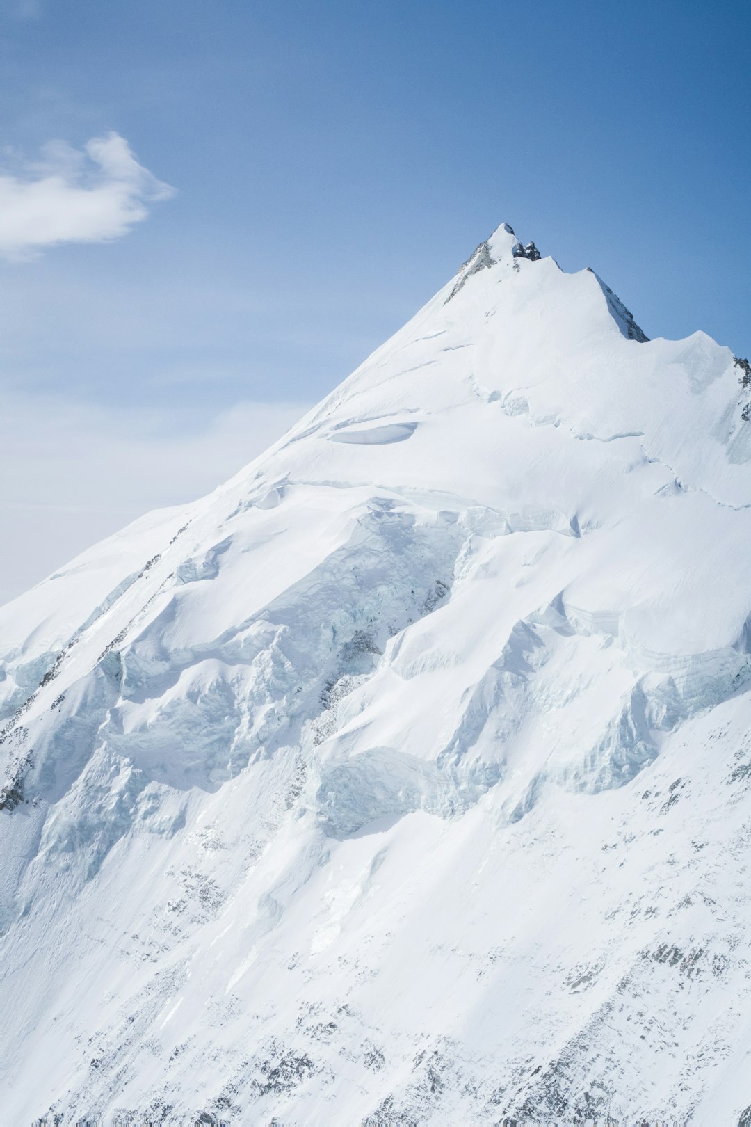 snow covered mountain under blue sky during daytime