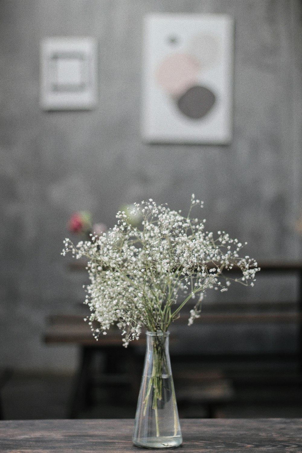 white and yellow flowers on brown wooden table