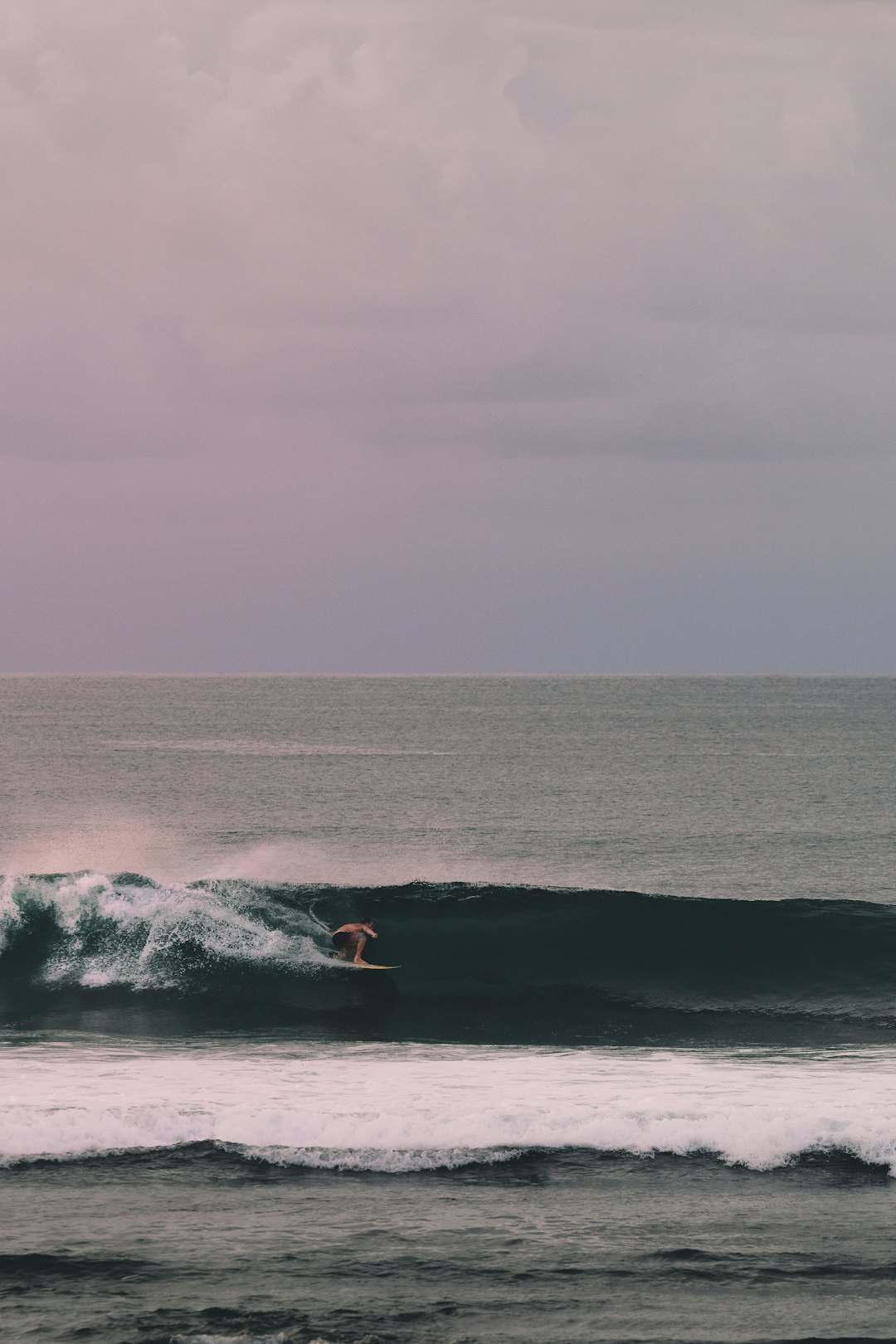 person surfing on sea waves during daytime