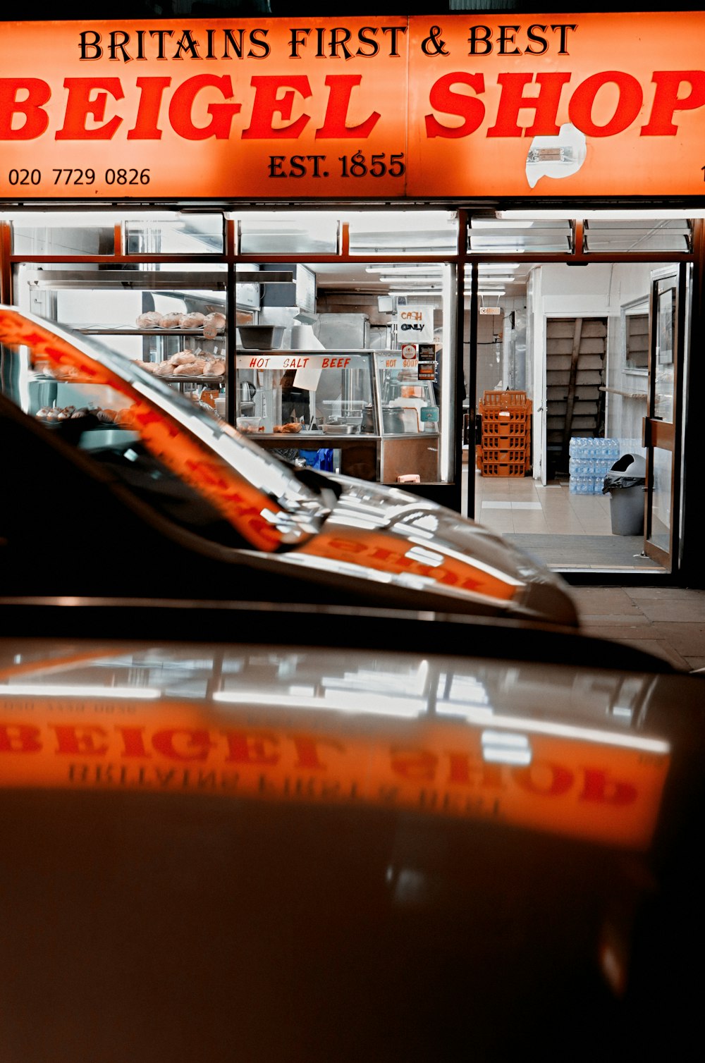 black car parked in front of store