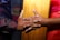 Close-up of hands exchanging a business contract over a wooden table.