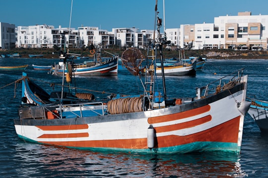 white and brown boat on water during daytime in Rabat Morocco