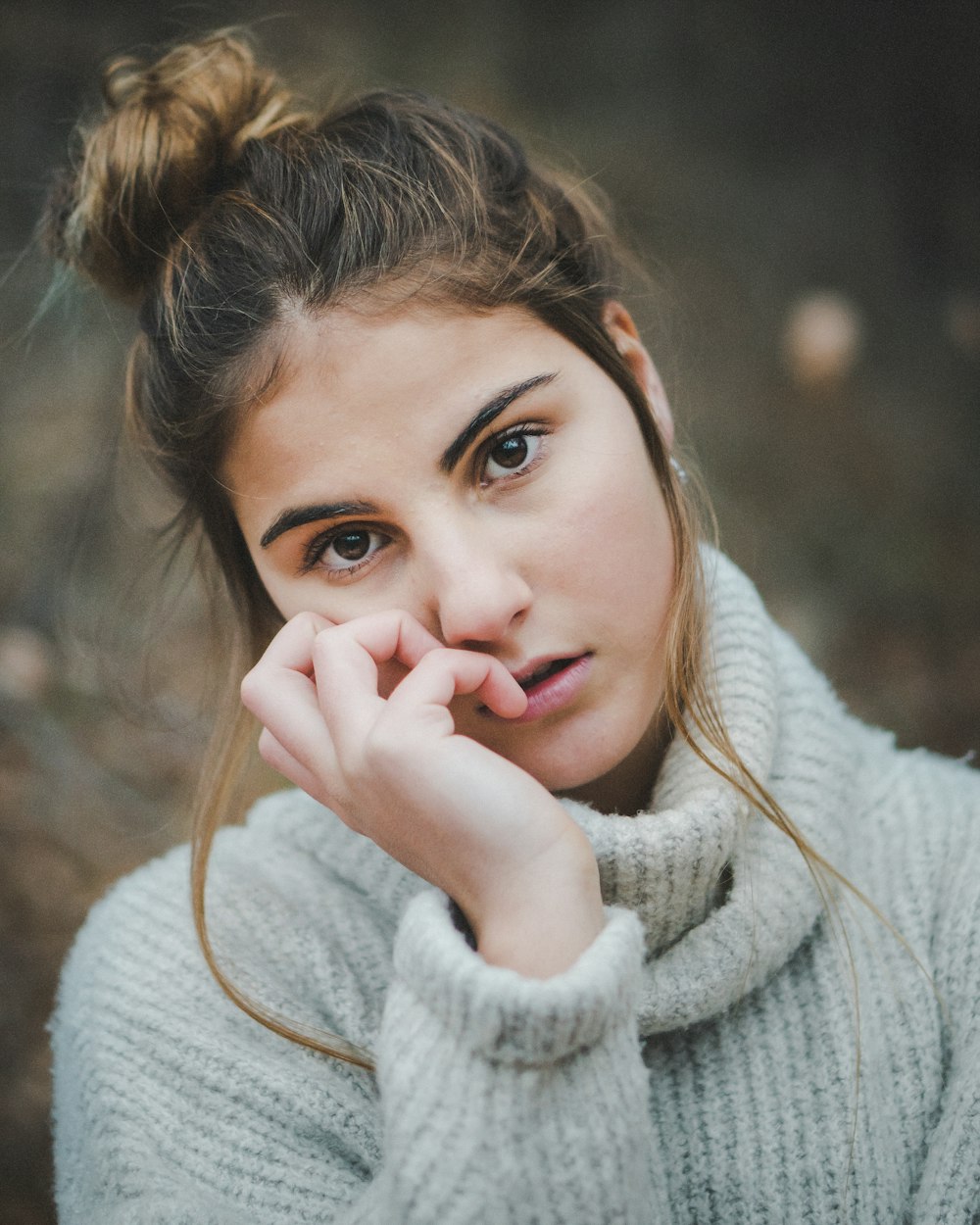 woman in white sweater with brown hair