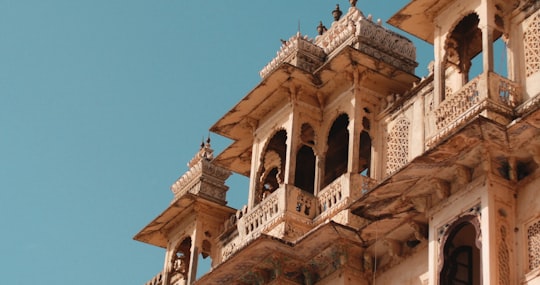 brown concrete building under blue sky during daytime in Udaipur India