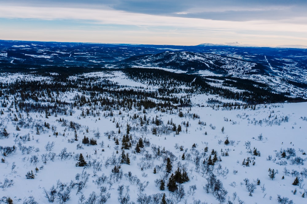 snow covered mountain under cloudy sky during daytime