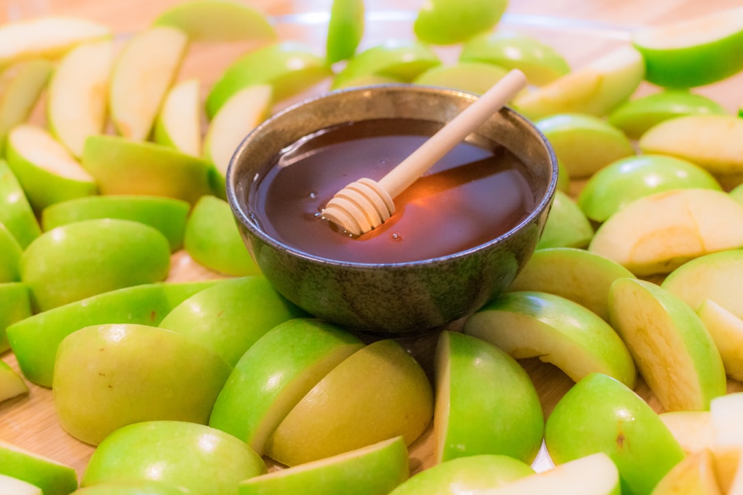 brown wooden spoon on green round fruit