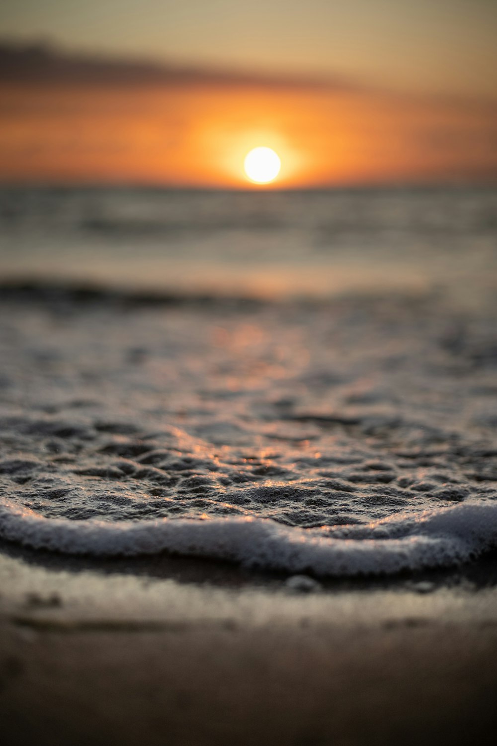 brown sand on beach during sunset