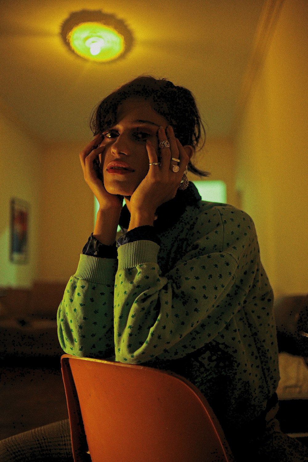 woman in purple and white polka dot long sleeve shirt covering her face