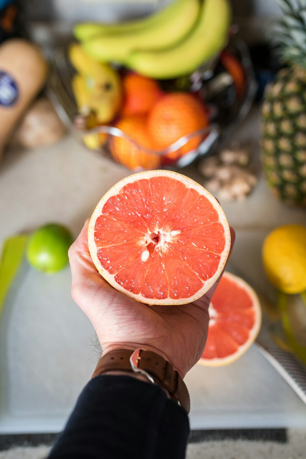 person holding sliced orange fruit