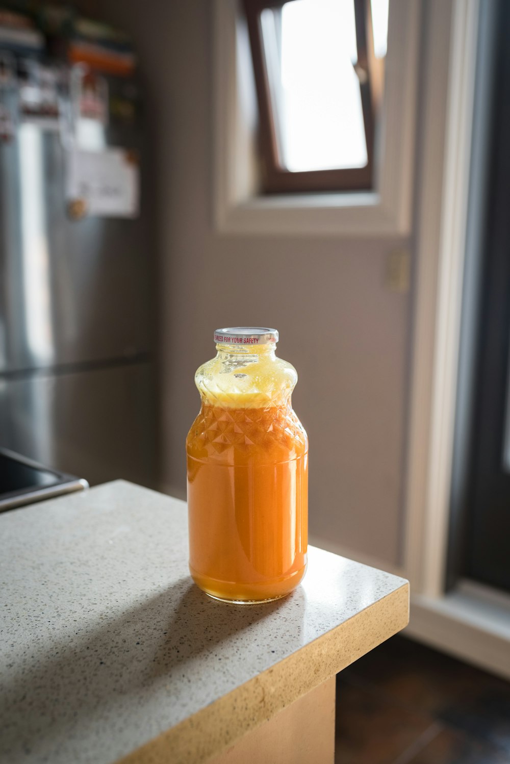 yellow liquid in clear glass jar