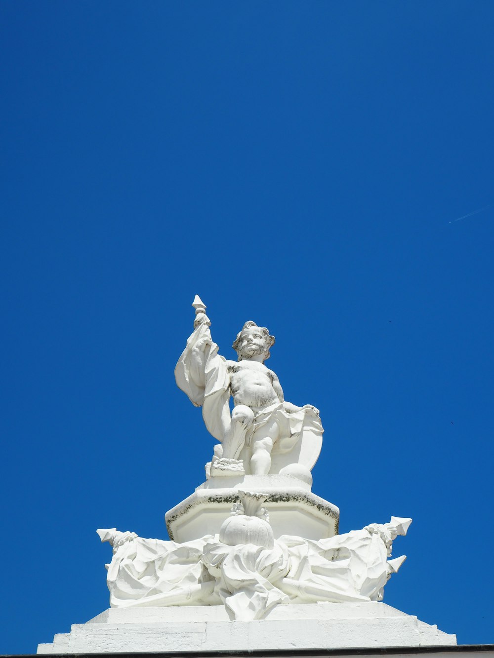 white concrete statue under blue sky during daytime