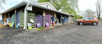 Colorful bags of organic fertilizers stacked neatly in a warehouse.