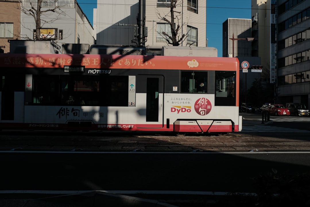 red and white tram on road during daytime