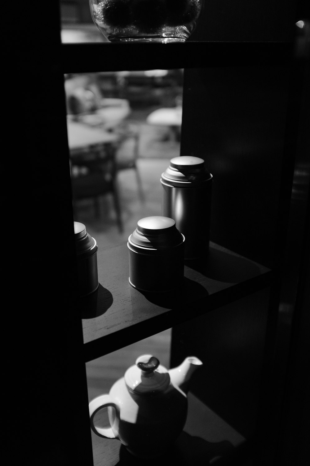 black and white condiment shakers on black wooden table