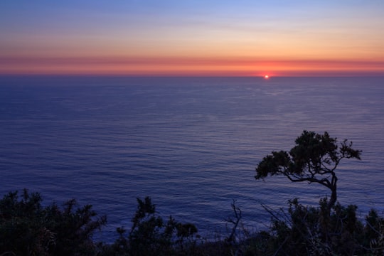 green trees near body of water during sunset in Cabo de Home Spain