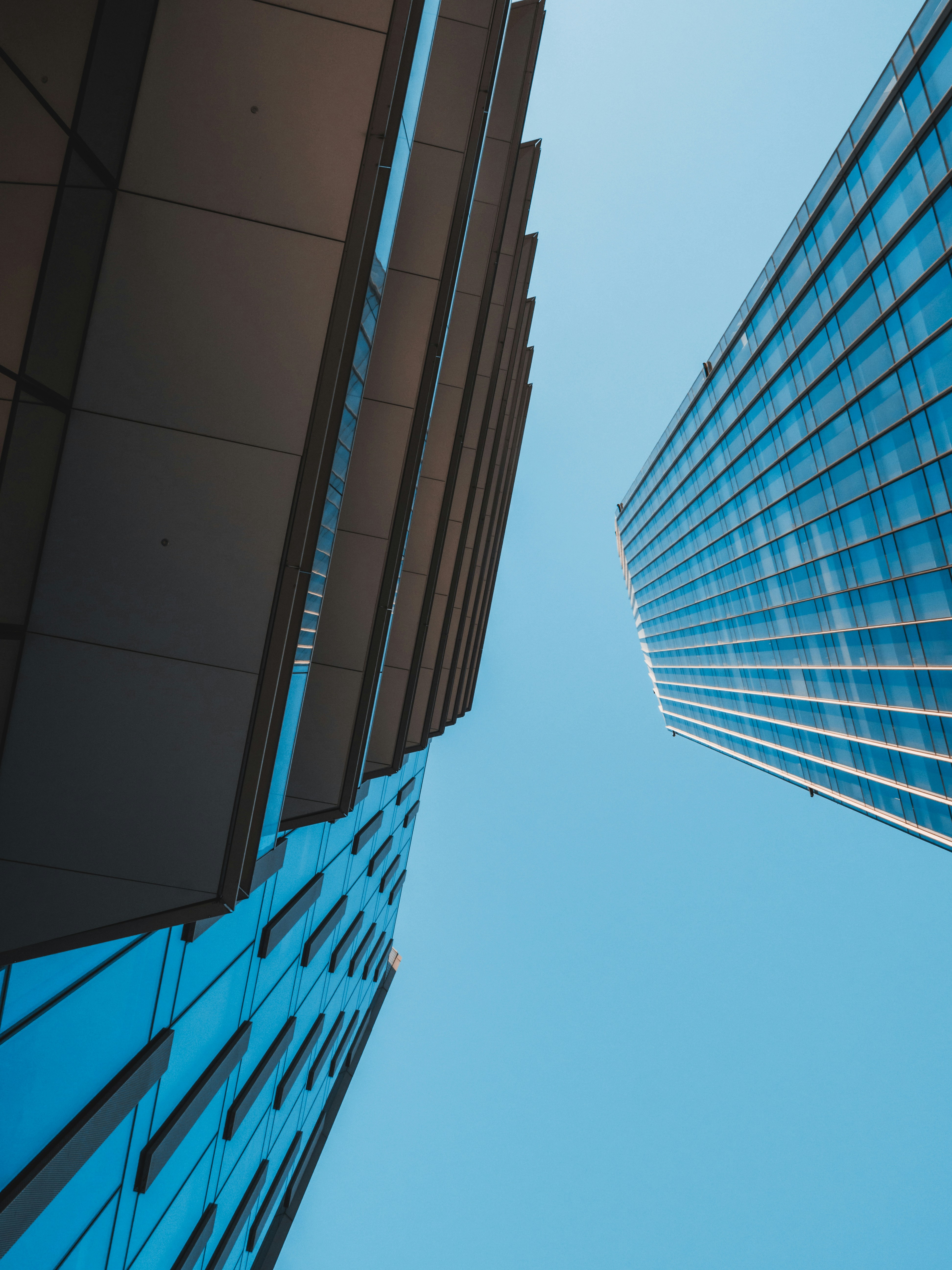 blue and white glass walled high rise building
