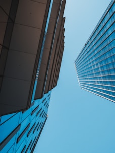 blue and white glass walled high rise building