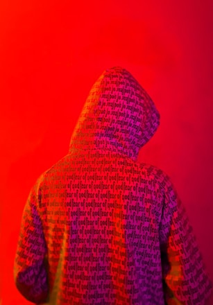 Close-up of a vibrant purple to orange gradient hoodie with detailed laser engraving and high-definition DTF print.