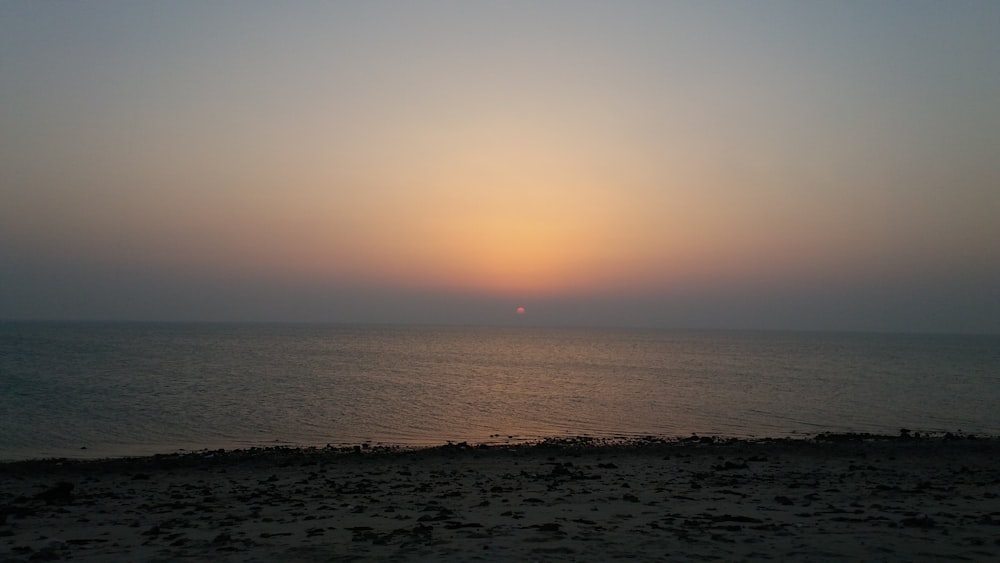 body of water during sunset