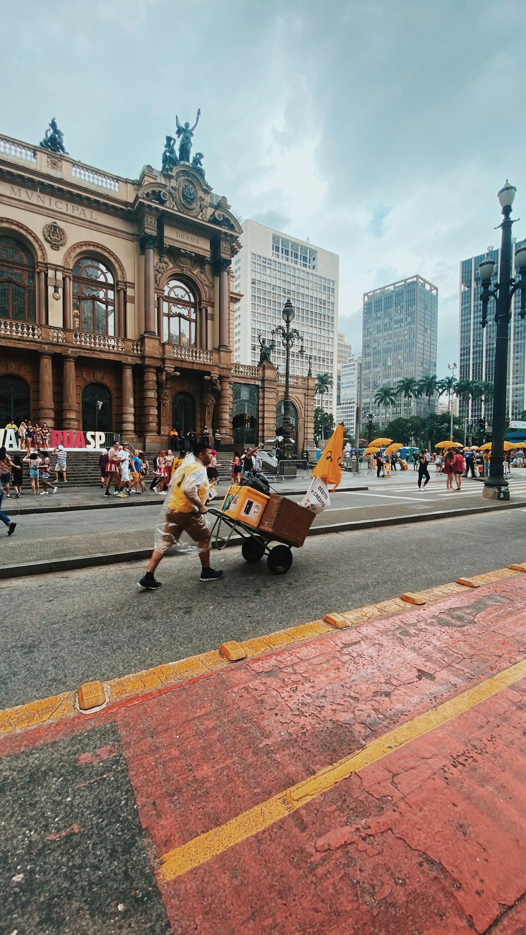 man in white shirt and brown pants playing guitar on street during daytime