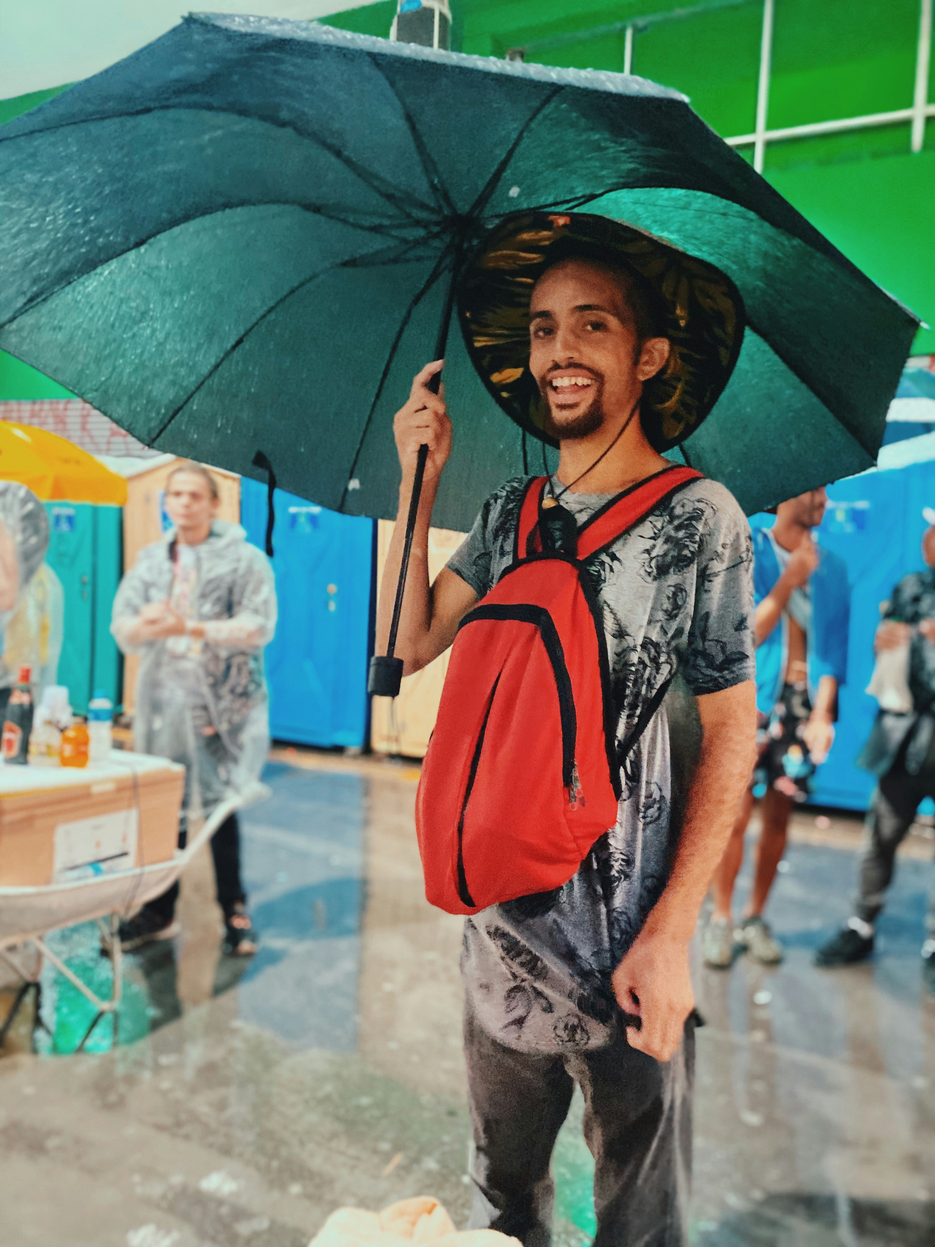 woman in black and orange floral shirt holding umbrella