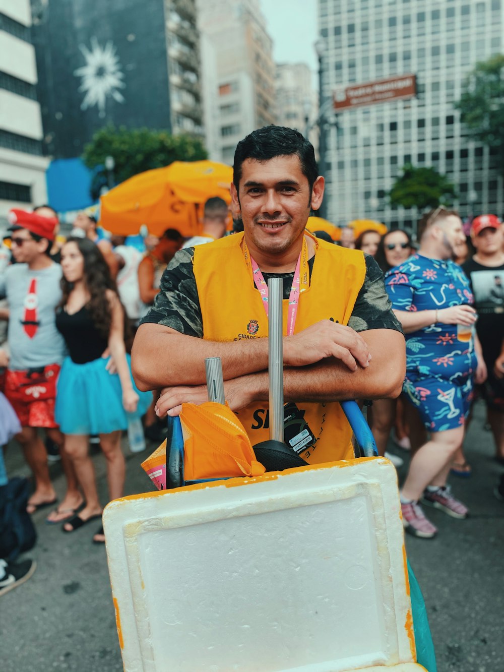 man in blue and yellow polo shirt sitting on yellow plastic chair