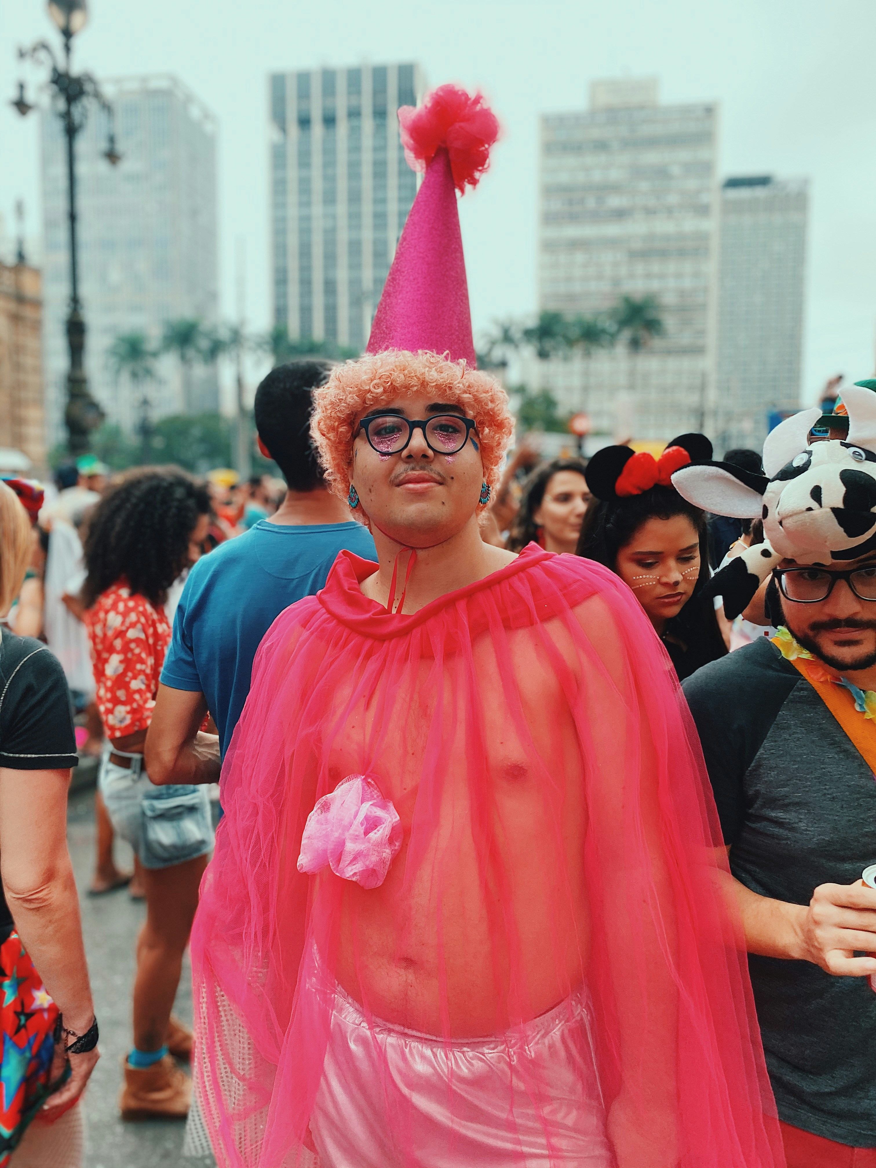 man in pink crew neck t-shirt wearing sunglasses