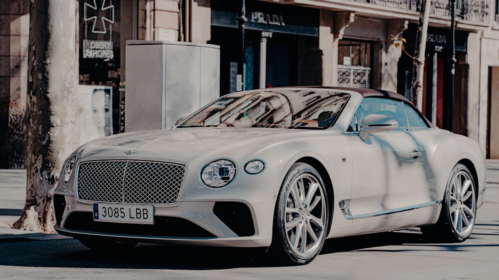 white mercedes benz coupe parked near building