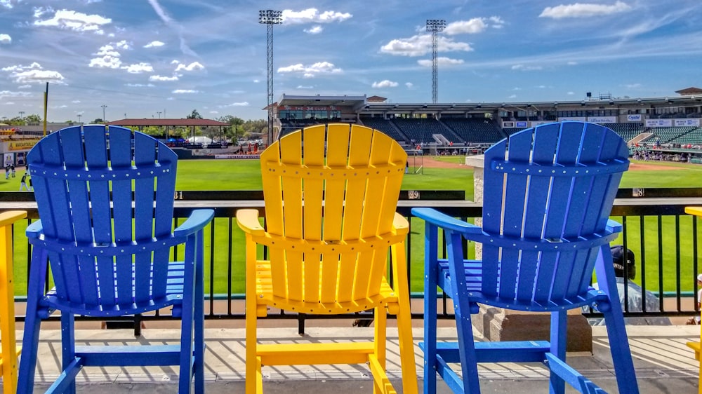 blue plastic armchair on green grass field during daytime