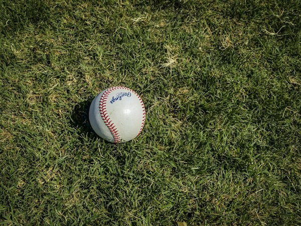 A baseball resting on green grass, a reminder that fans who catch a foul ball at a Banana Ball game in Las Vegas can record an out