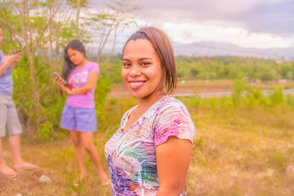 girl in pink blue and white floral dress smiling