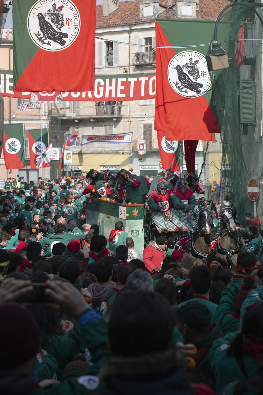 people gathering in front of red and white UNK building during daytime