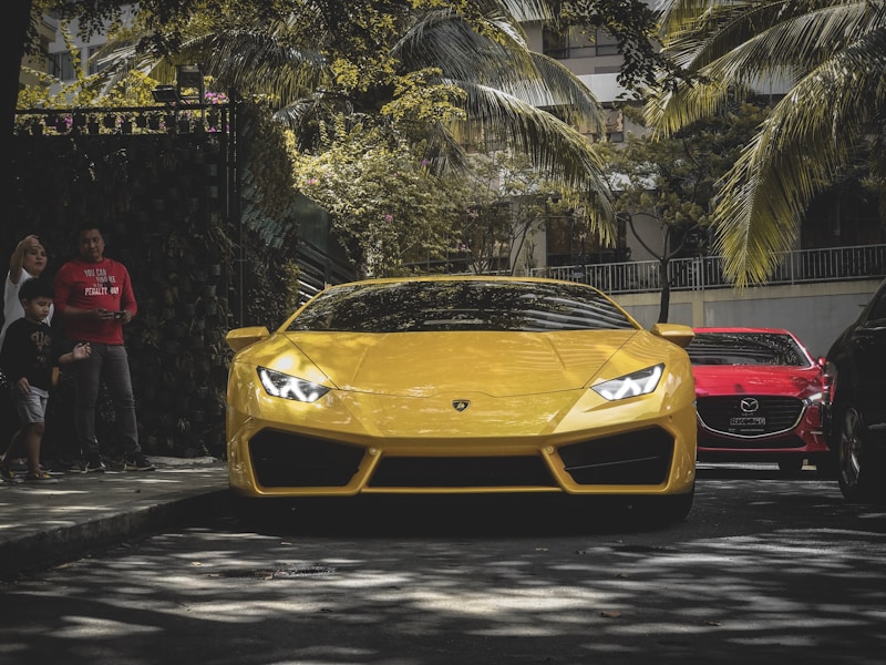 Luxury yellow Porsche by trees