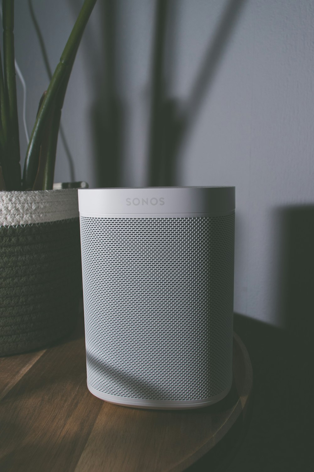 gray and black speaker on brown wooden table