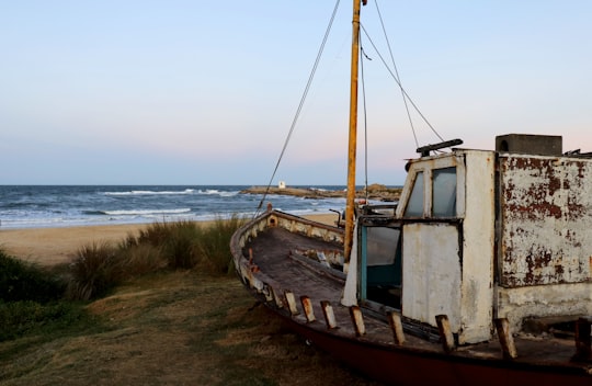 brown and white boat on seashore during daytime in Punta del Diablo Rocha Uruguay