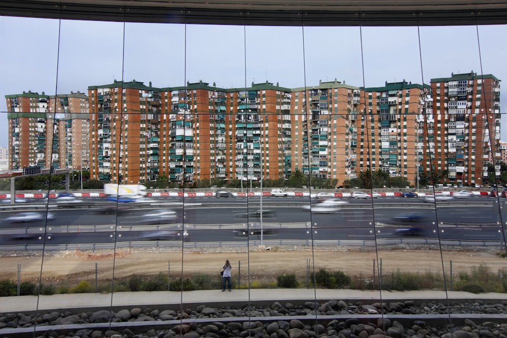 people walking on sidewalk near high rise buildings during daytime