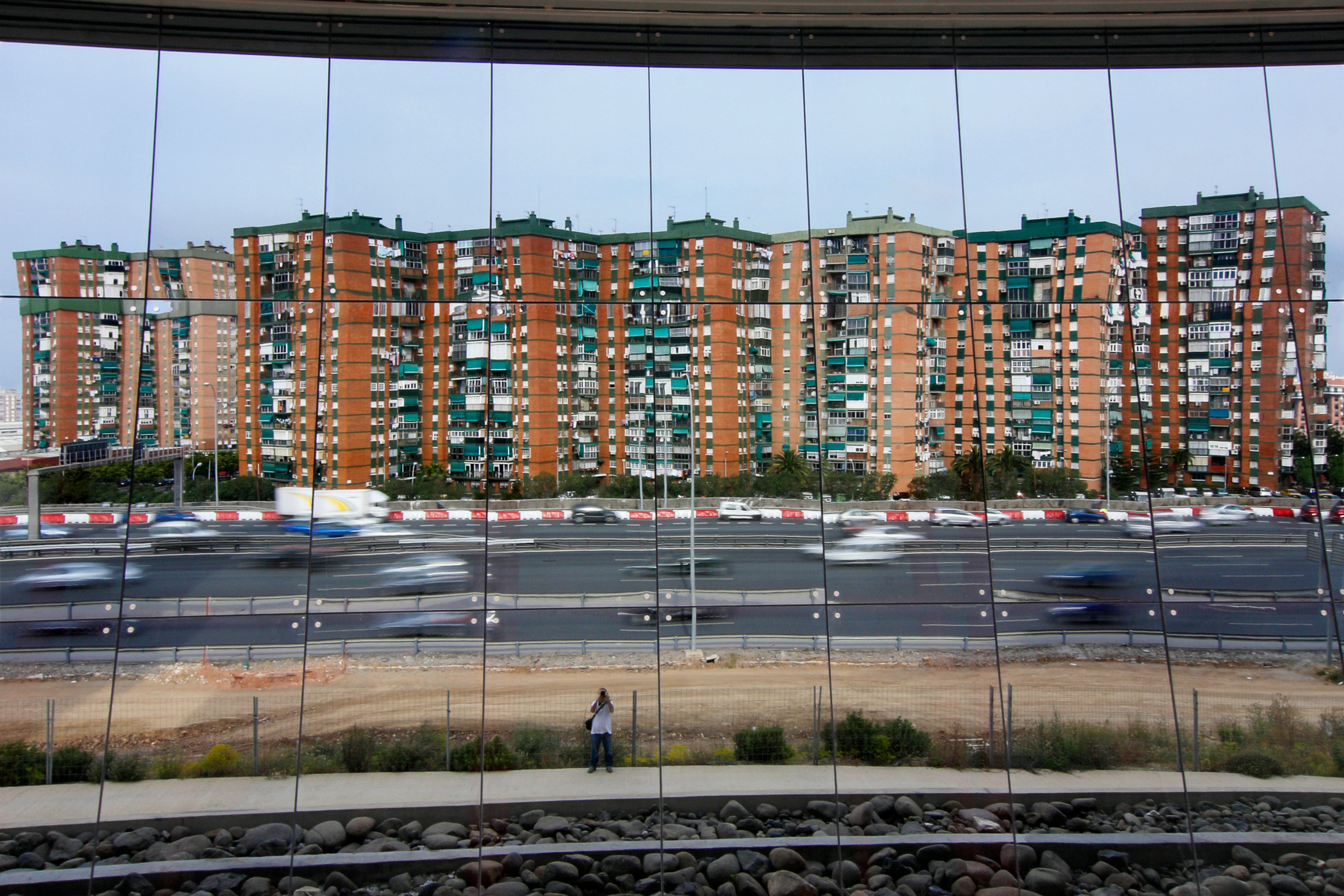 people walking on sidewalk near high rise buildings during daytime