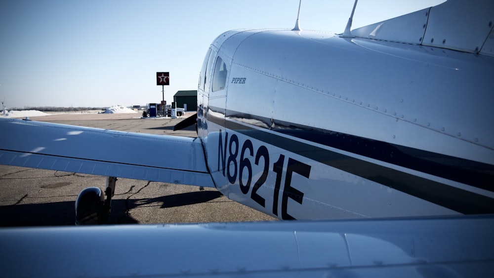 white and blue airplane under blue sky during daytime