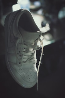 Elegant women's sneakers in pastel tones displayed on a clean white background with subtle shadows.