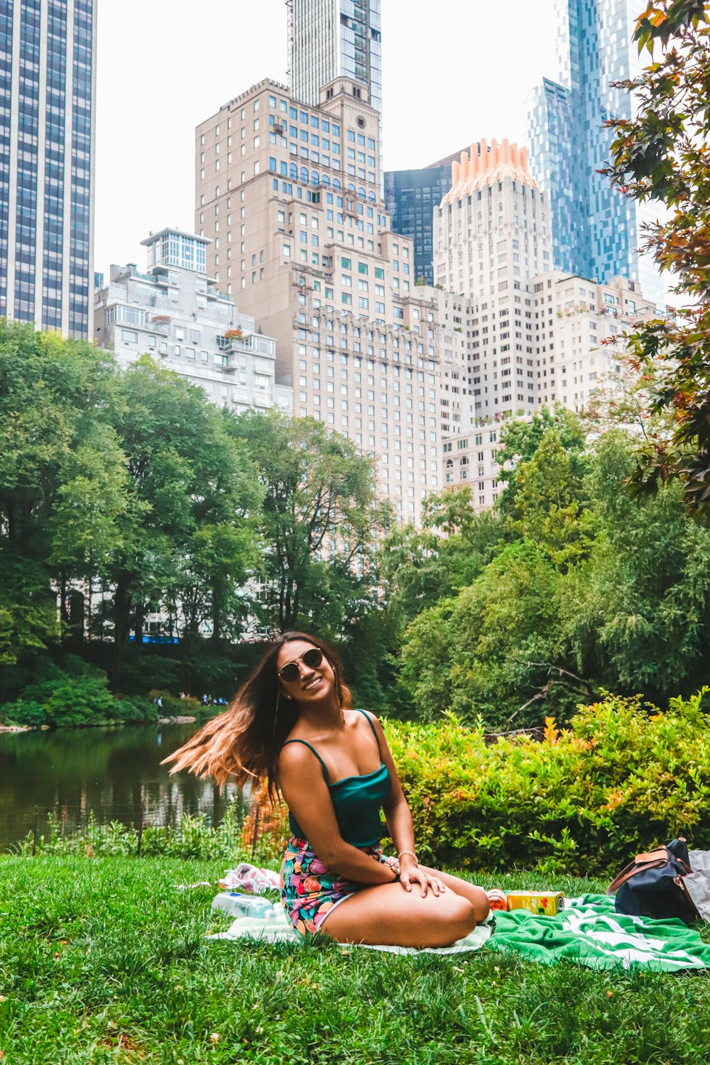 woman in blue tank top standing near river during daytime