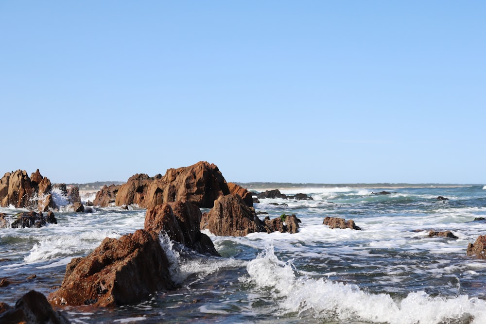 brown rock formation on sea during daytime