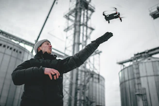 A confident engineer operating a drone over a rugged mining site, illustrating advanced technology in action.