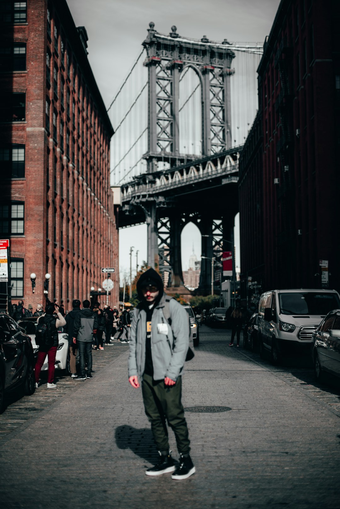 man in white jacket walking on street during daytime