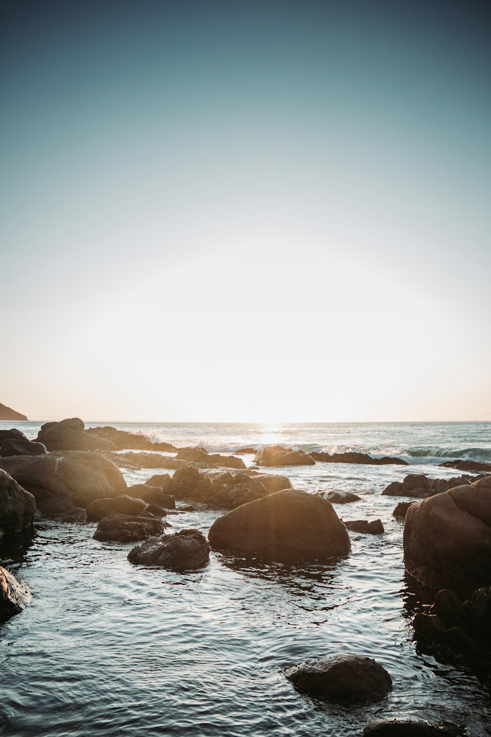 brown rocks on sea shore during daytime